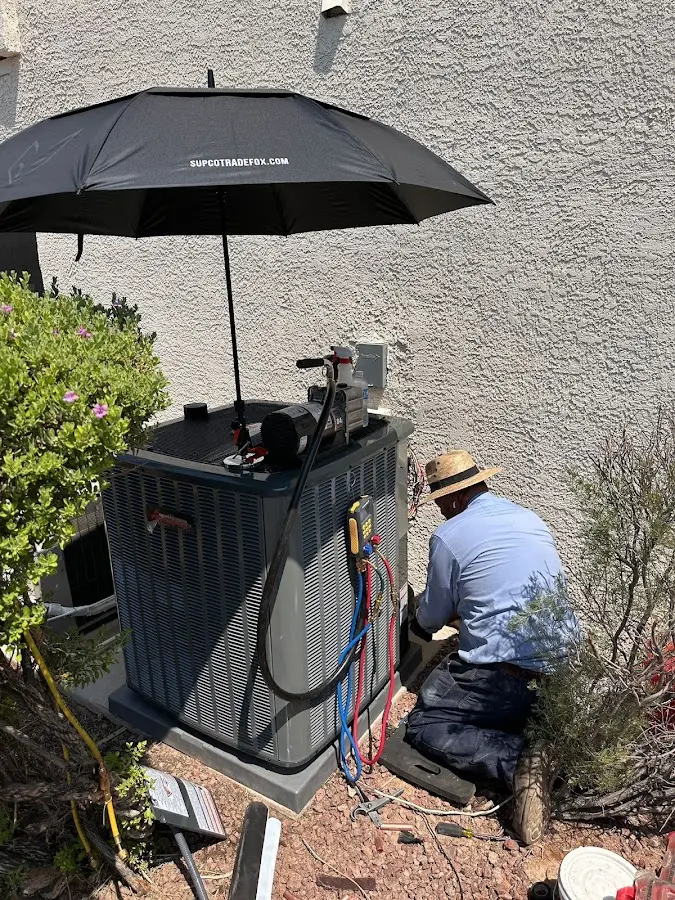 HVAC technician performing outdoor AC maintenance in Manteca